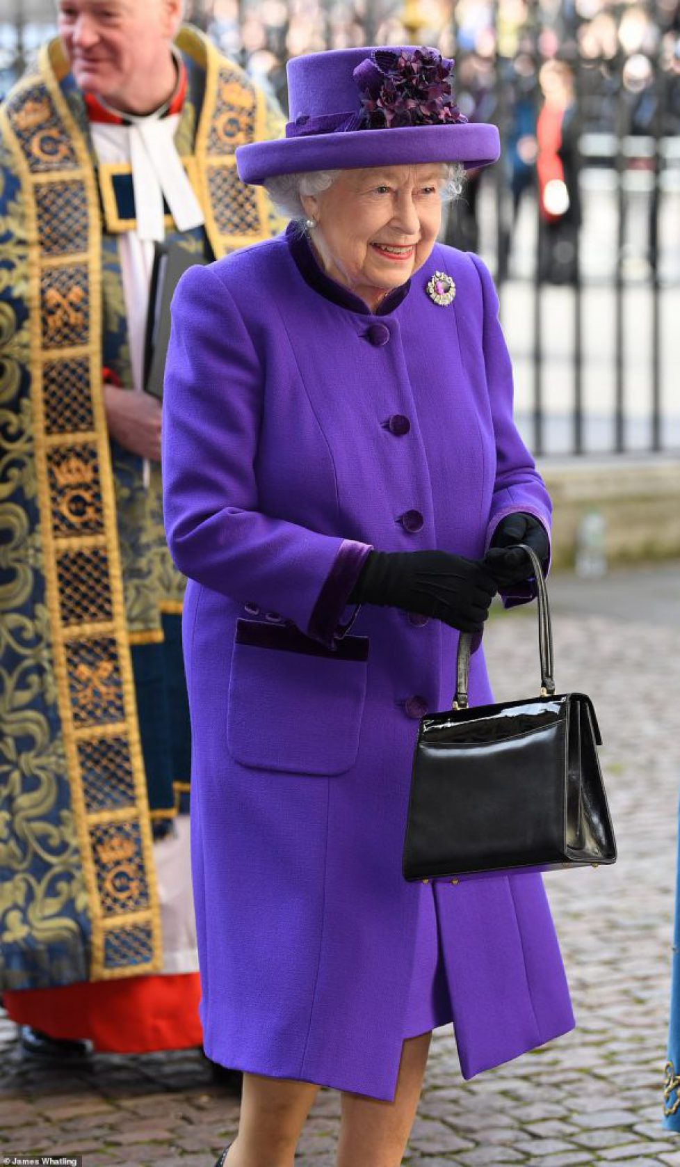 10840522-6795345-The_Queen_opted_for_a_bold_purple_ensemble_as_she_donned_a_match-m-83_1552317775188