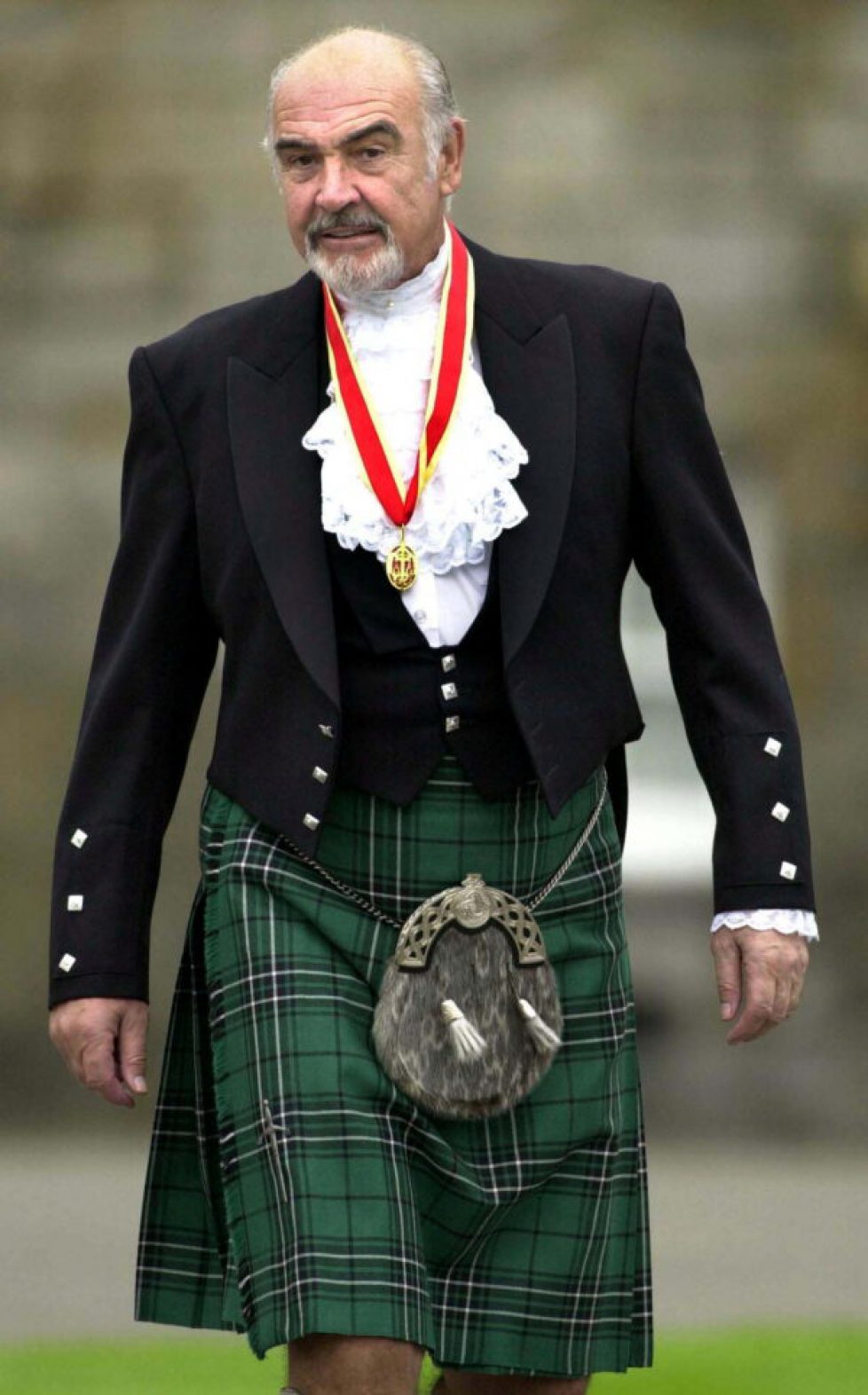 FILE PHOTO: Sir Sean Connery wearing full highland dress walks towards waiting journalists after he was formally knighted by the Britain's Queen Elizabeth at Holyrood Palace in Edinburgh
