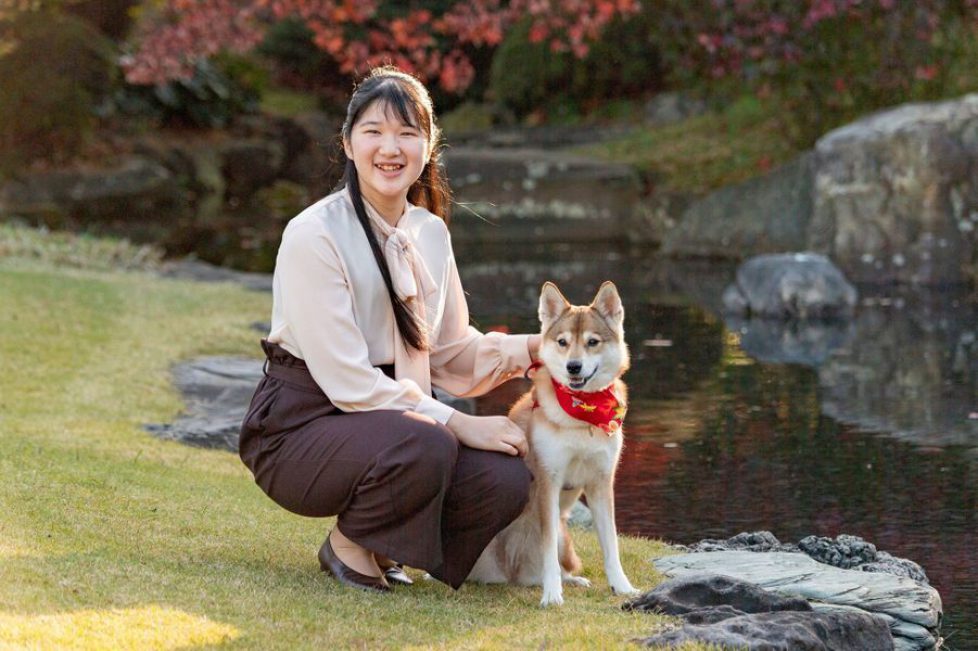 Japan's Princess Aiko, daughter of Emperor Naruhito and Empress Masako, poses for a photograph with her pet dog Yuri in Tokyo